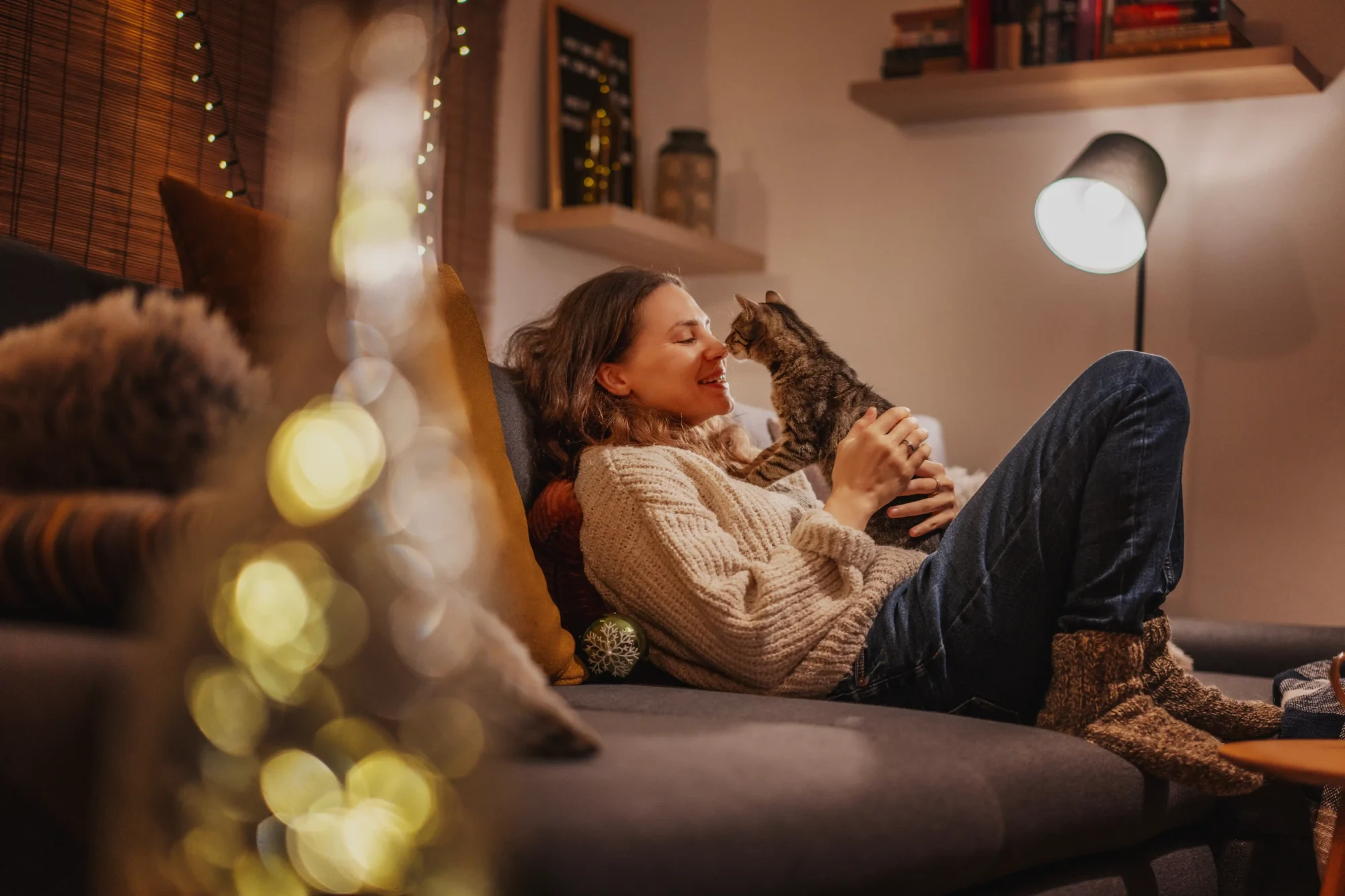 woman sitting on a couch with a cat