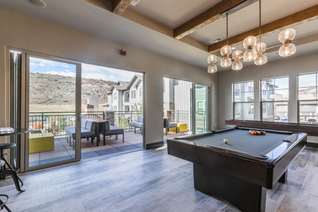 Clubhouse lounge with billiards table and patio seating