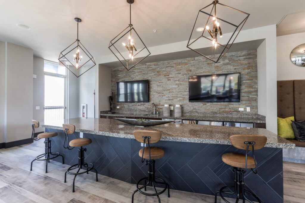 Clubhouse kitchen with bat seating and TVs
