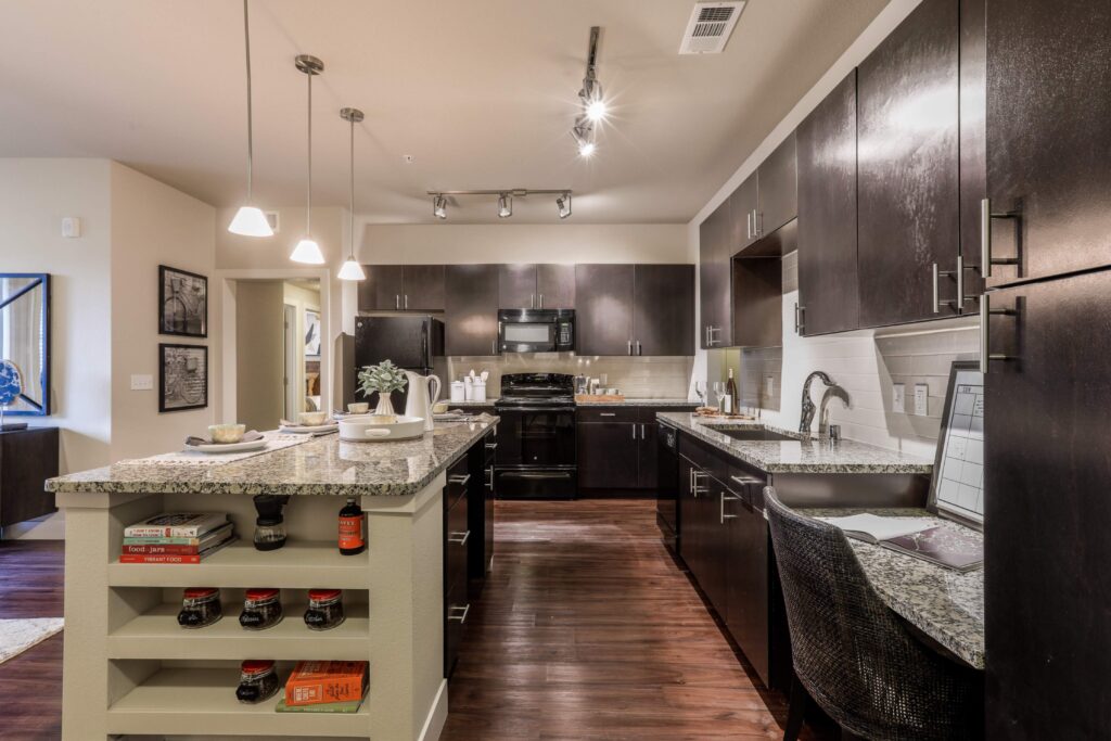 Kitchen with granite counters, stainless steel appliances, and built in desk