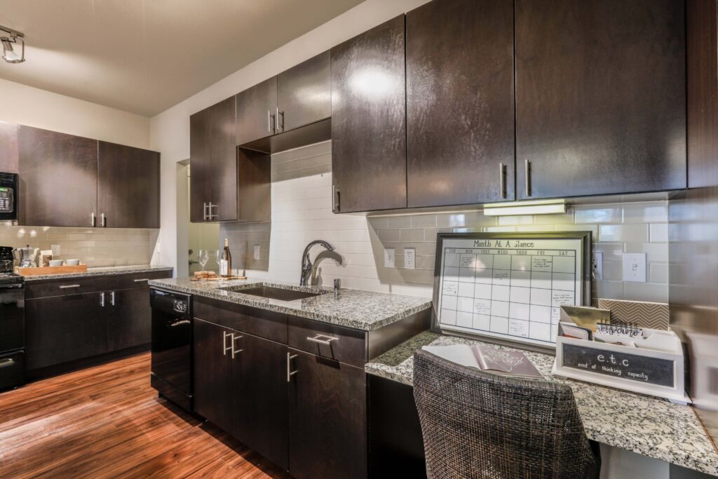 Kitchen with granite counters, stainless steel appliances, and built in desk