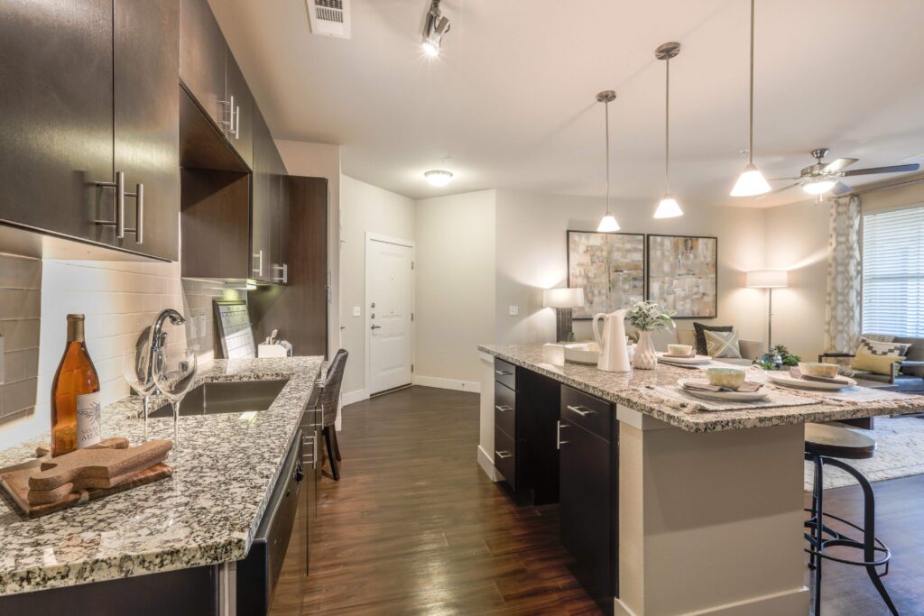 Kitchen with granite counters, stainless steel appliances, and built in desk