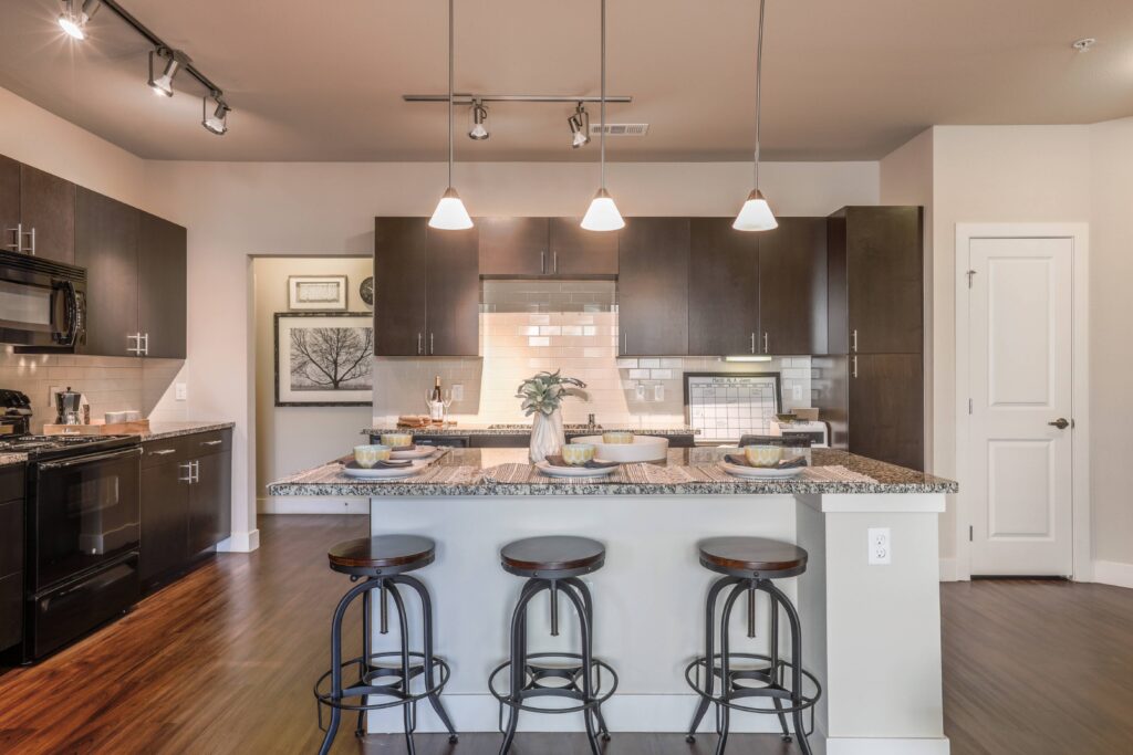 Kitchen with granite counters, stainless steel appliances, and built in desk