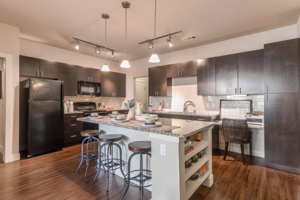 Kitchen with granite counters, stainless steel appliances, and built in desk