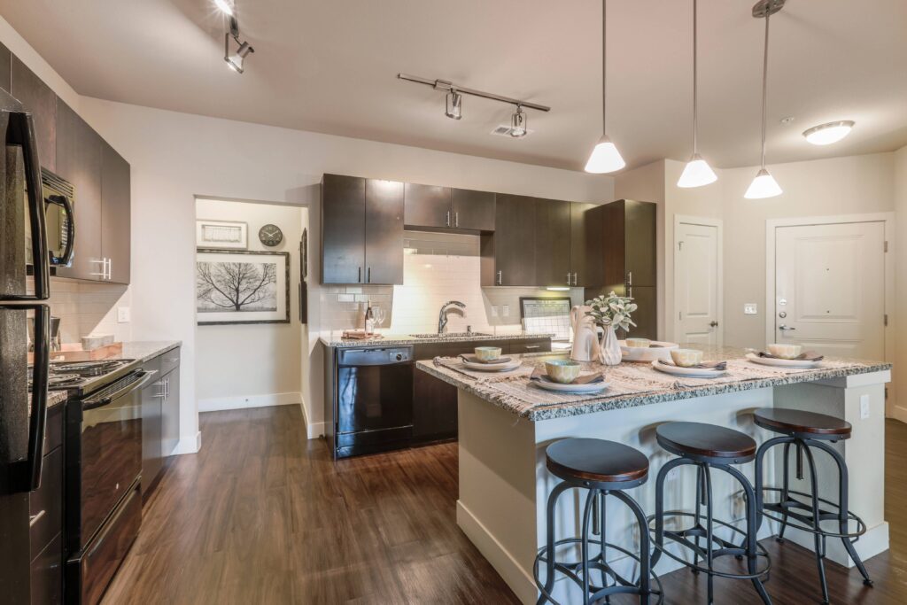 Kitchen with granite counters, stainless steel appliances, and built in desk